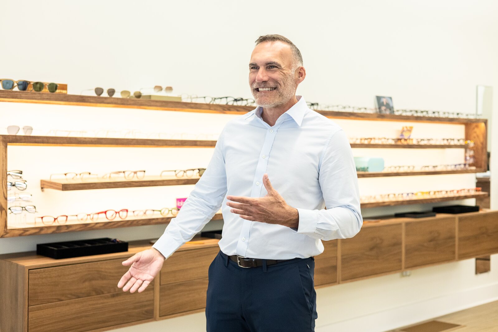 Dr. John Ormando in the Ardmore Eye & Optical optical boutique, surrounded by independent and designer frames